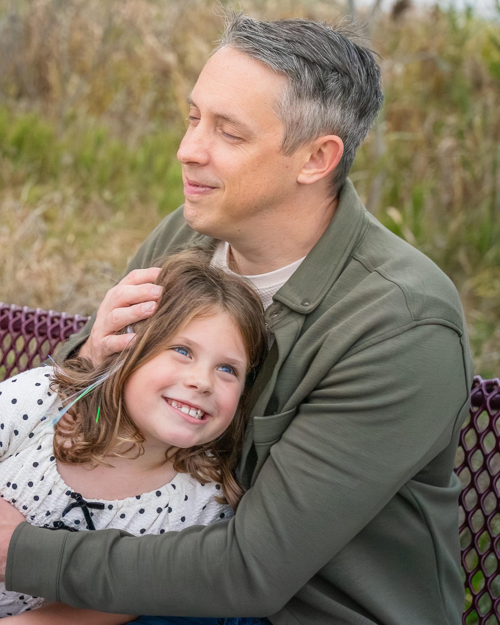 Dad enjoying a sweet moment with his daughter
